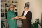 Joyce handing the original family bible over to Sister Bertrand